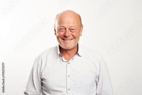 Portrait of a smiling senior man in white shirt on white background