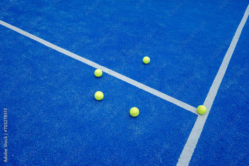 three balls on a paddle tennis court, selective focus,