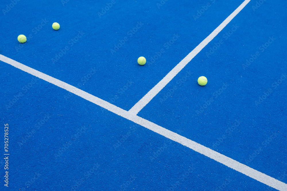 selective focus, four balls on a paddle tennis court.