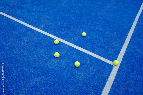 three balls on a paddle tennis court, selective focus, © Vic