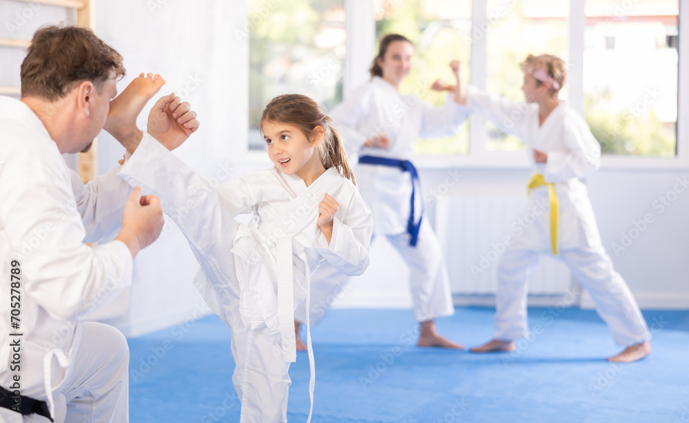 Parent with child partners during martial arts karate class train to
