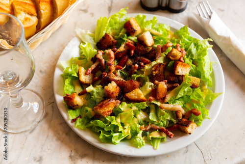 French cuisine, traditional homemade Salade aux lardons - salad with bacon, crackers and lettuce