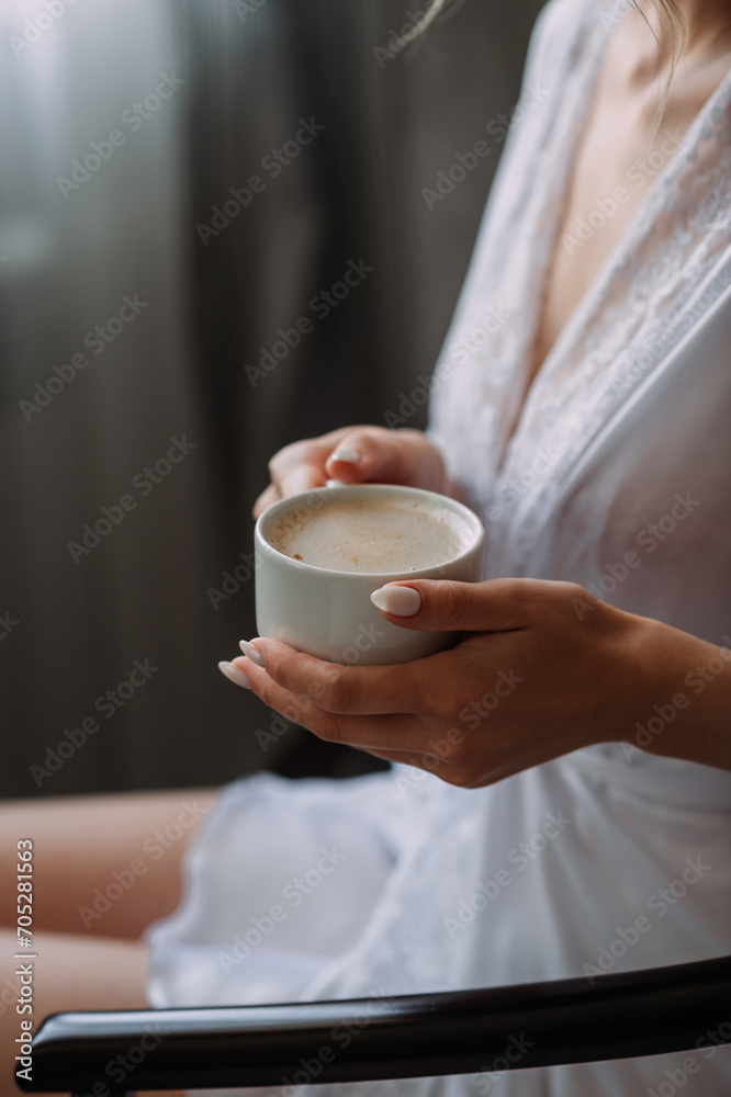 The image is of a woman in a wedding dress holding a cup of coffee 5231. The image is of a woman in a wedding dress holding a cup of coffee 5231.