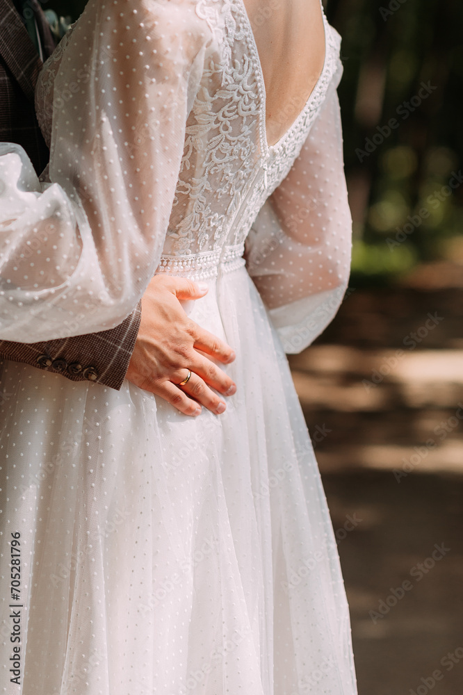 The image is of a person wearing a white wedding dress with lace embellishments and a bridal veil. 5263