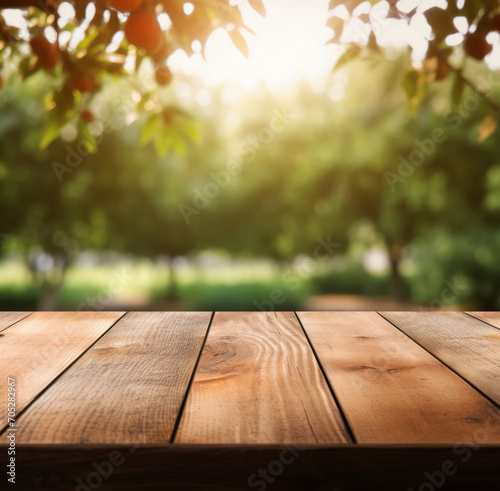 Empty wooden table, texture board, on a blurred background of an fruits garden in blurred bokeh