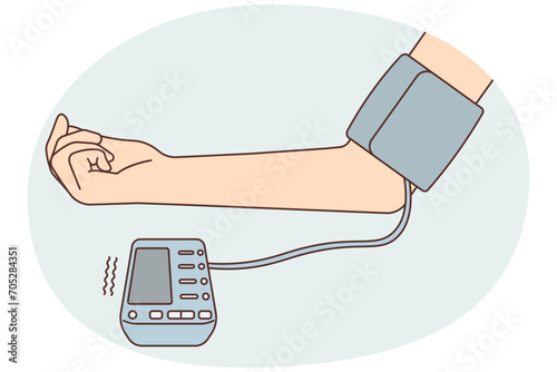 Patient hand with blood pressure monitor