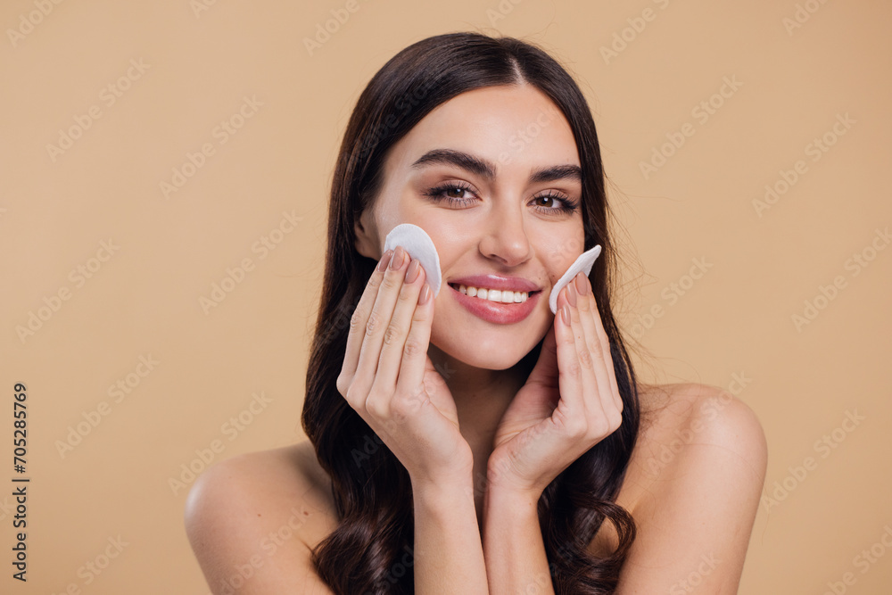 © anatoliycherkas - Beautiful brunette half-naked woman removes makeup from the face with a cotton pad © anatoliycherkas - Beautiful brunette half-naked woman removes makeup from the face with a cotton pad