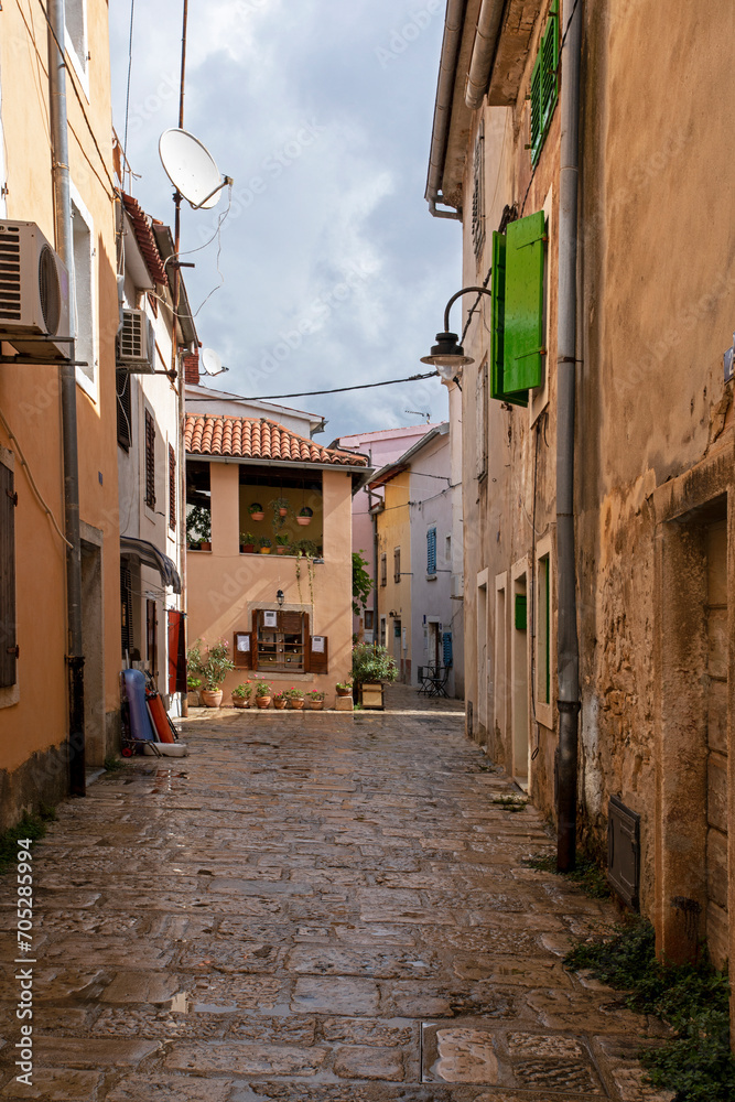 narrow street with houses in Croatia on a cloudy day