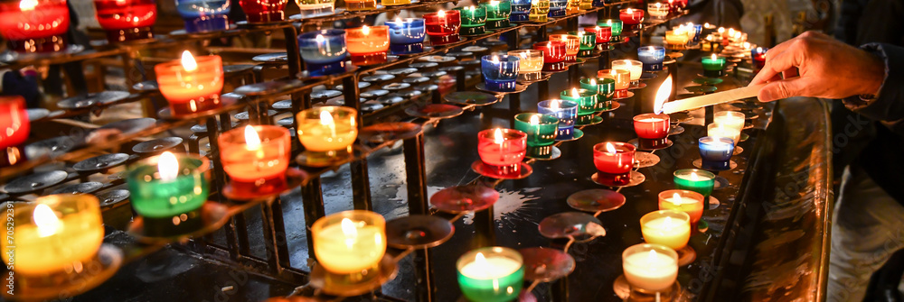 rows of prayer candles burning in the church cathedral rows of prayer candles burning in the church cathedral