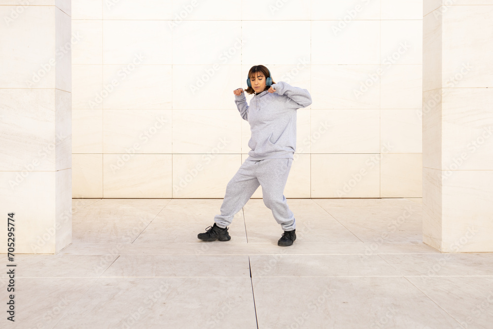 © ADDICTIVE STOCK - Active woman dancing in casual sportswear