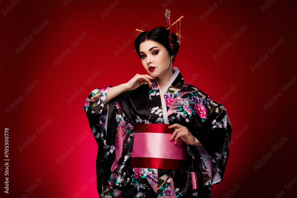 Photo of lovely lady dressed traditional floral print flowers black kimono isolated on red gradient color background Photo of lovely lady dressed traditional floral print flowers black kimono isolated on red gradient color background
