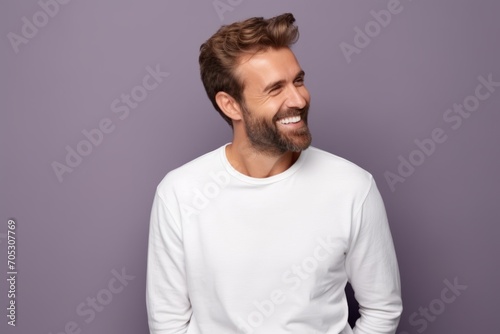 Handsome young man in white t-shirt on violet background © Igor
