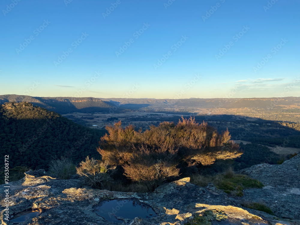 Spectacular views from a mountain-top lookout. Mountains in the horizon. Blue mountains, Australia. Grand canyon sunset. Unusual rock formation. Summit of the mountain.
