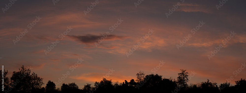 Landscape at sunset. Tragic gloomy sky. The village in the Budjak steppe. The terrain in southern Europe. Panorama. Crimson twilight.