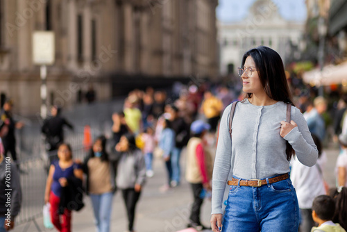 Young woman walking and enjoying the squares and streets of a tourist city
