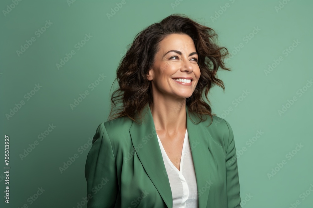 smiling businesswoman in green jacket looking up isolated on green background smiling businesswoman in green jacket looking up isolated on green background