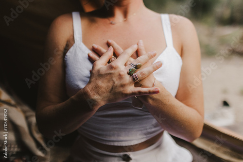 Woman holding her hands over her heart