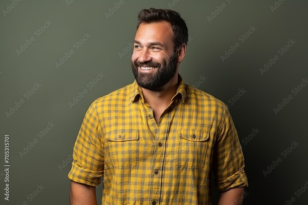 Portrait of a handsome bearded man smiling and looking at camera.