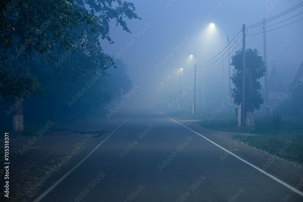 mysterious fog on the street in a small town at night