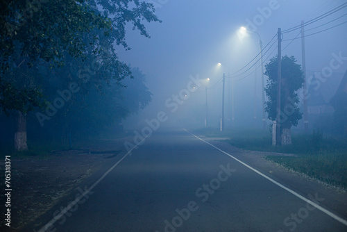 Fototapeta Naklejka Na Ścianę i Meble -  mysterious fog on the street in a small town at night
