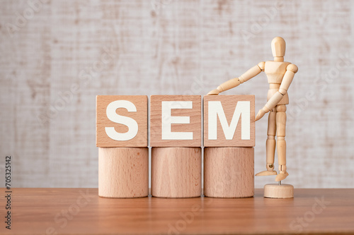 There is wood cube with the word SEM. It is an abbreviation for Search Engine Marketing as eye-catching image.