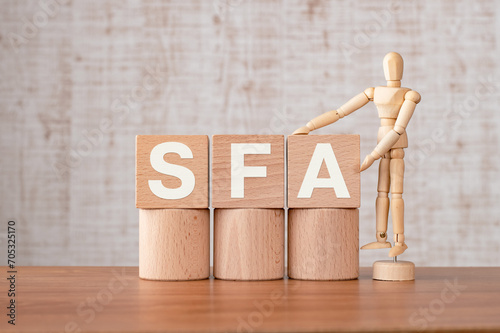 There is wood cube with the word SFA. It is an abbreviation for Sales Force Automation as eye-catching image.