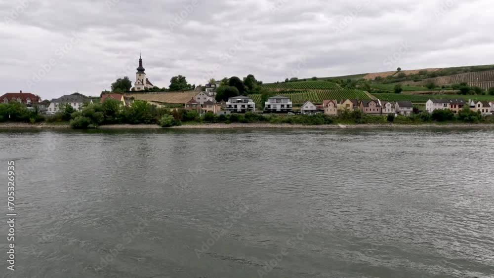 Traveling along the Rhine River with scenic views of the medieval town of Trebur, Germany. Views of colorful European style architecture and vineyards on the sloping land