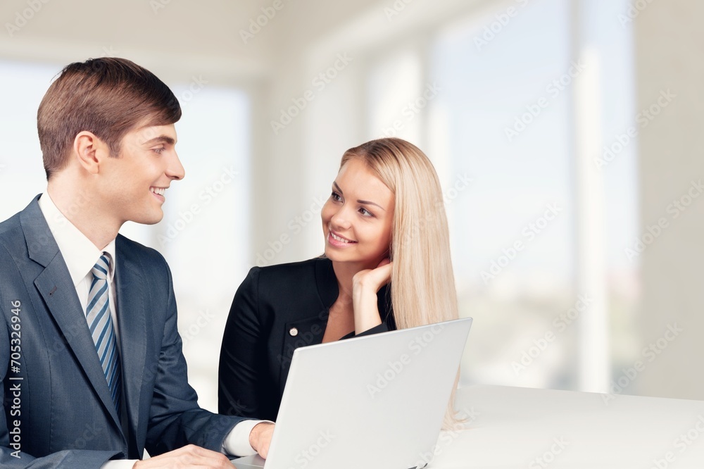 Two business people discussing financial papers at the meeting. Two business people discussing financial papers at the meeting.