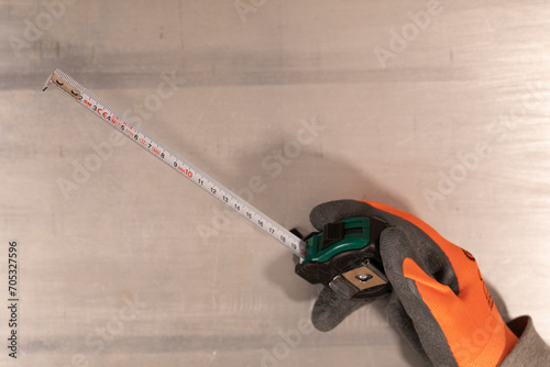 Gloved hand holding a measu...