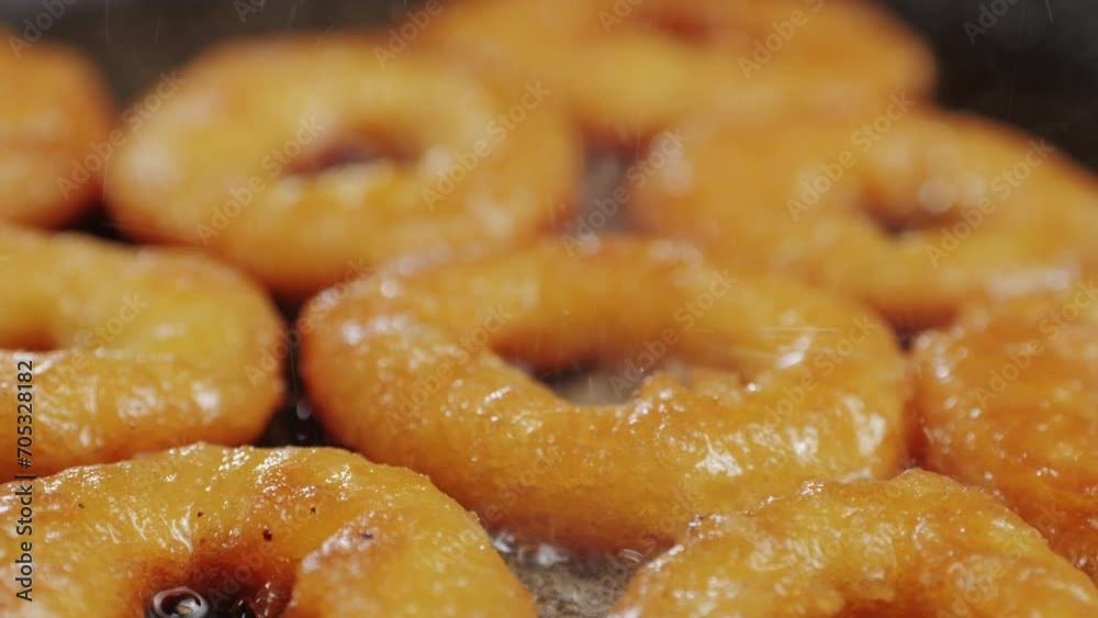 Fried crispy onion rings in a frying pan with oil close-up macro. Roasted onion rings for snacks at bar, cafe. Fast food. Delivery. Beer snacks Fried crispy onion rings in a frying pan with oil close-up macro. Roasted onion rings for snacks at bar, cafe. Fast food. Delivery. Beer snacks
