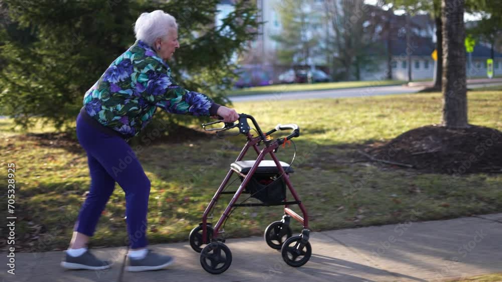 Side view of elderly senior woman pushing a walker, rolling it on a sidewalk outside for exercise and mobility. Side view of elderly senior woman pushing a walker, rolling it on a sidewalk outside for exercise and mobility.