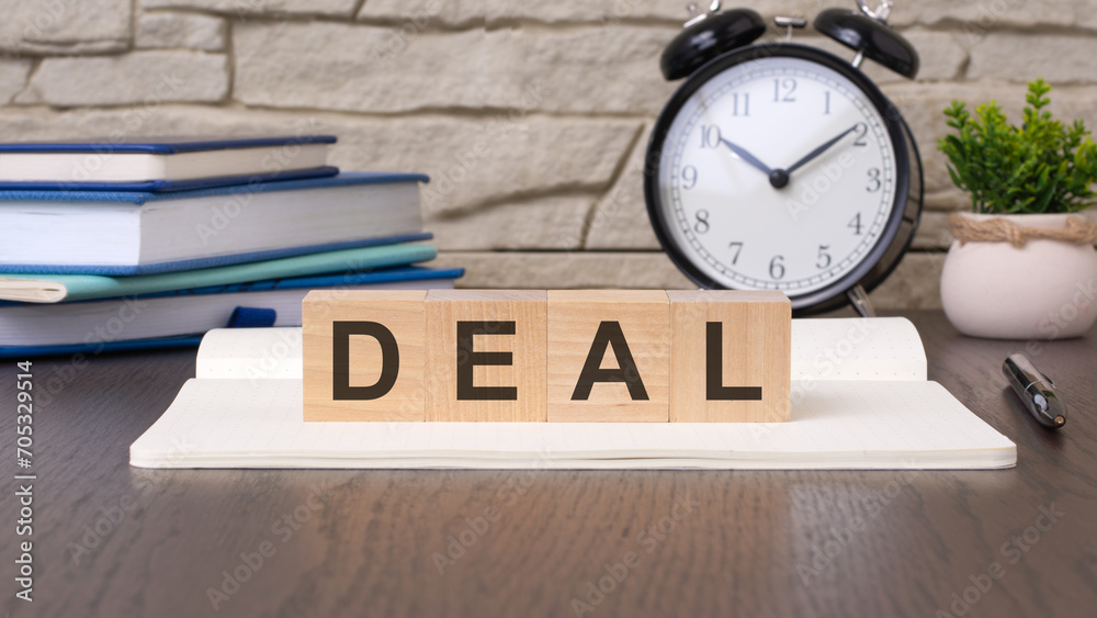 word Deal on wooden cubes on office table with yellow background. business deal concept. word Deal on wooden cubes on office table with yellow background. business deal concept.