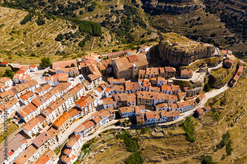 View from drone of Ares del Maestrat, small ancient town on mountain slopes on sunny fall day, Spain photo