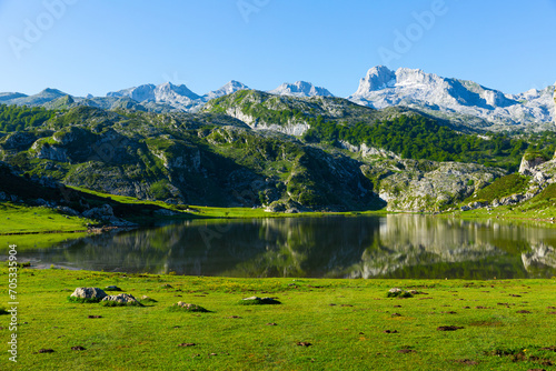 Serene landscape with one of Lakes of Covadonga and mountain range in summer day photo