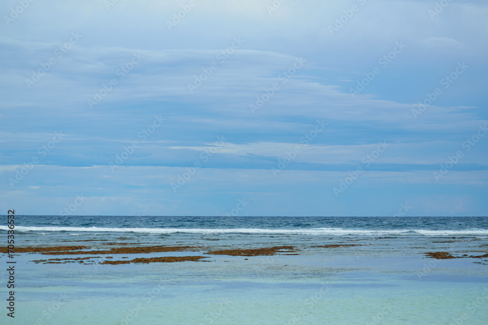 An amazingly beautiful uninhabited tropical beach with clear, clean ocean water on the popular tourist island of Bali.