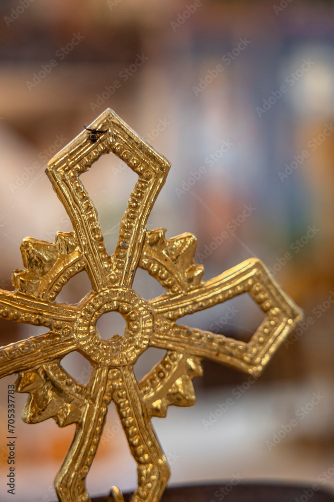 Golden cross in a church with a spider and a spider web. Orthodox Church in Bulgaria. Golden cross in a church with a spider and a spider web. Orthodox Church in Bulgaria.