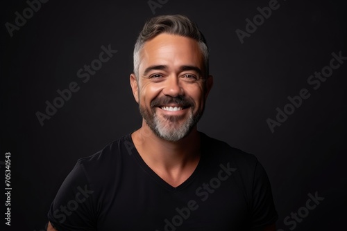 Portrait of a handsome middle-aged man on black background.