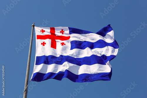 National flag of Georgia against the blue sky.