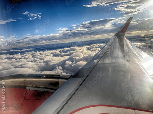 Wing of an airplane flying over the clouds