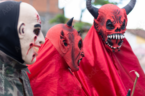 Unidentified people are seen wearing horror costumes and masks in the Acupe district in the city of Santo Amaro, Bahia. photo