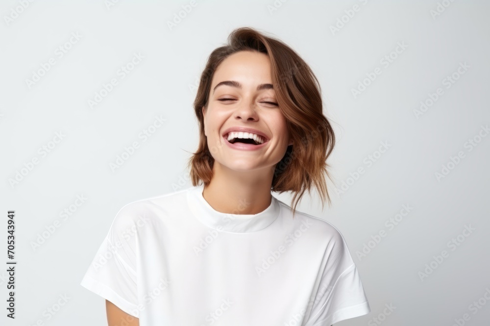 Portrait of a happy young woman laughing, isolated on white background Portrait of a happy young woman laughing, isolated on white background
