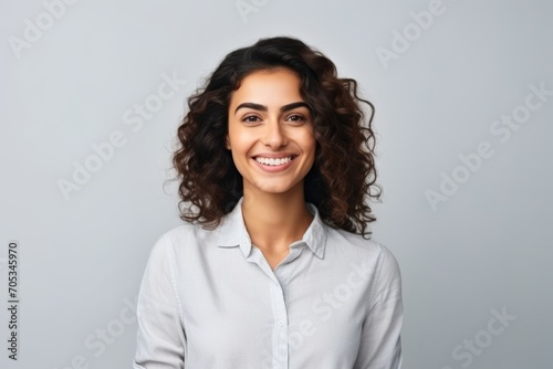 happy smiling young businesswoman or student in white shirt over grey background