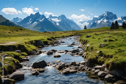 Alpine valley with river and snow capped mountains