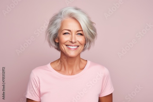 beauty, people and health concept - smiling senior woman over pink background