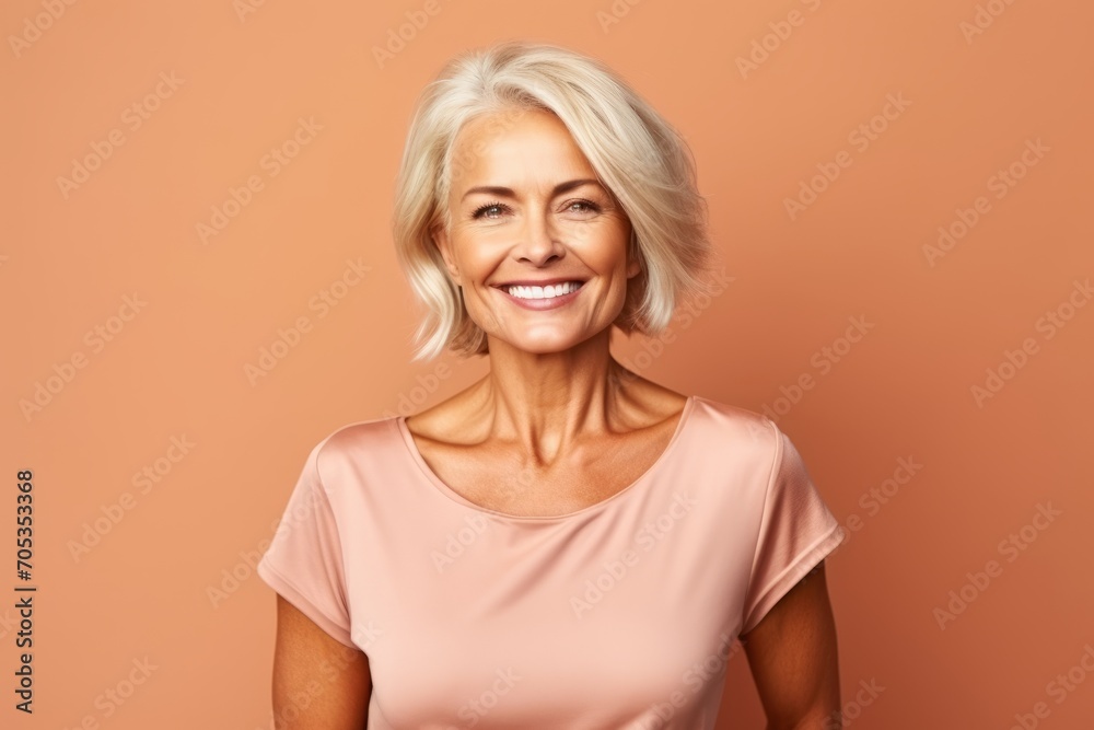Portrait of a beautiful mature woman smiling at the camera over brown background Portrait of a beautiful mature woman smiling at the camera over brown background