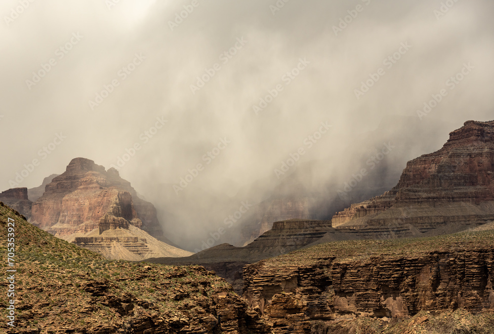 Thin Dark Clouds Break Over The Rim Of Grand Canyon