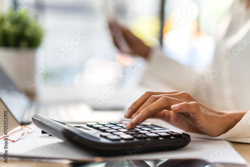 Human use calculator and calculate bills and paying bill, credit card, finance, tax, vat, payment, tax refund, budget, debt, money.financial managing budget and accounting concept photo