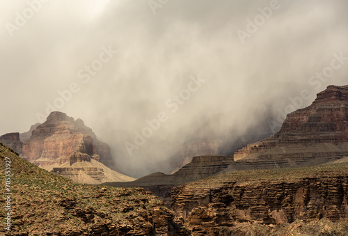 Thin Dark Clouds Break Over The Rim Of Grand Canyon
