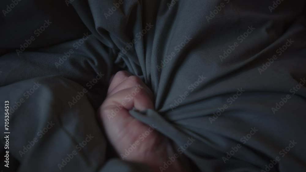 Woman's Hand Squeezing Pillow In Bed During Orgasm. Erotic Concept. closeup shot