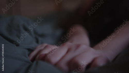 Closeup Of Female Hands Grabbing Bedsheet In Pleasure. Intimate Concept. photo